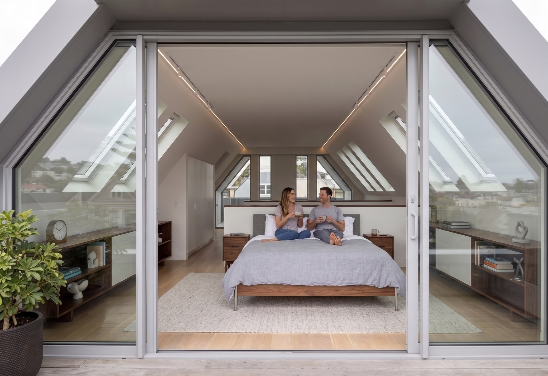 Bedroom opening onto a rooftop terrace through full-height glass doors